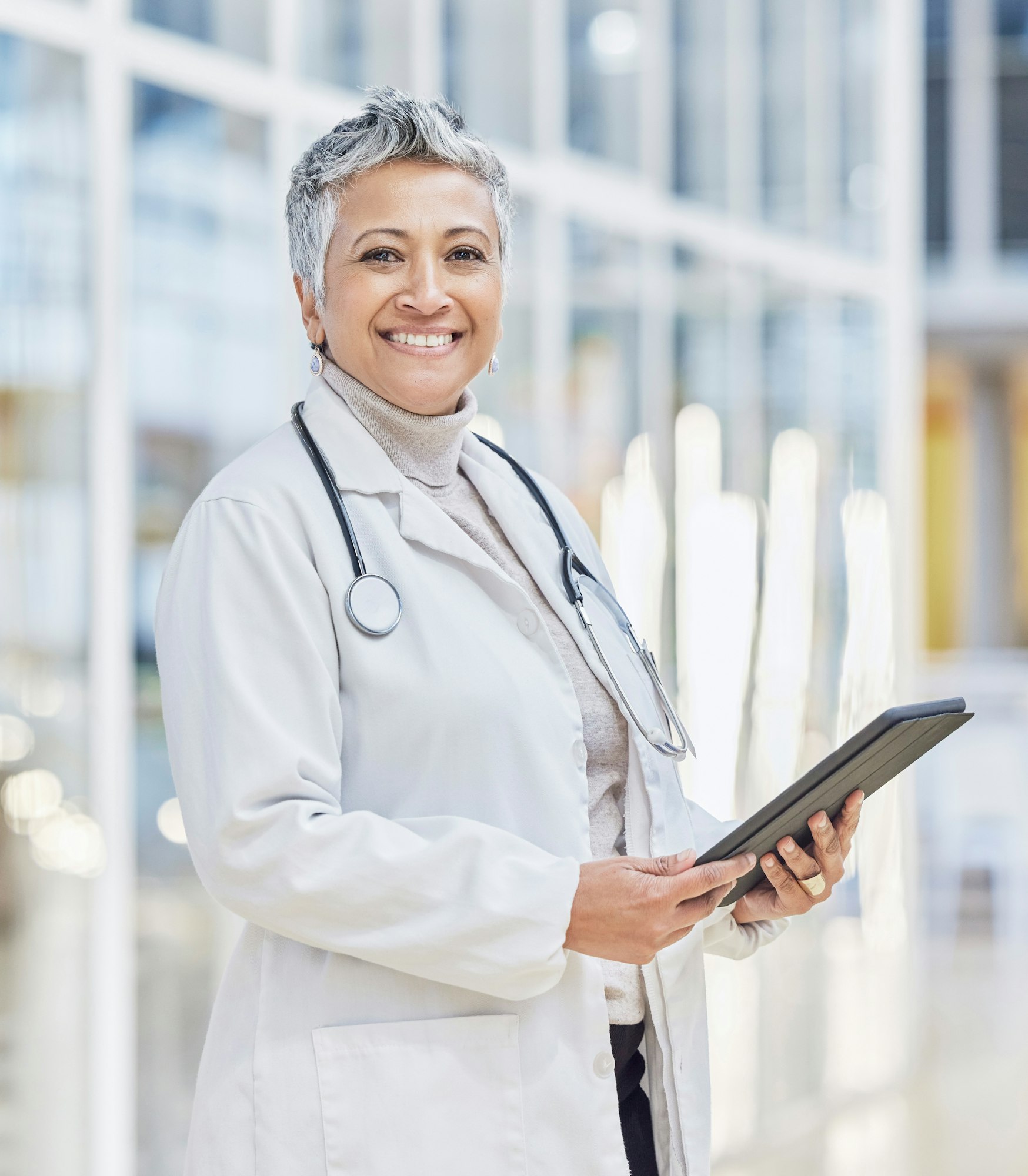 Portrait of doctor, woman and tablet for medical review, data research and healthcare in hospital.